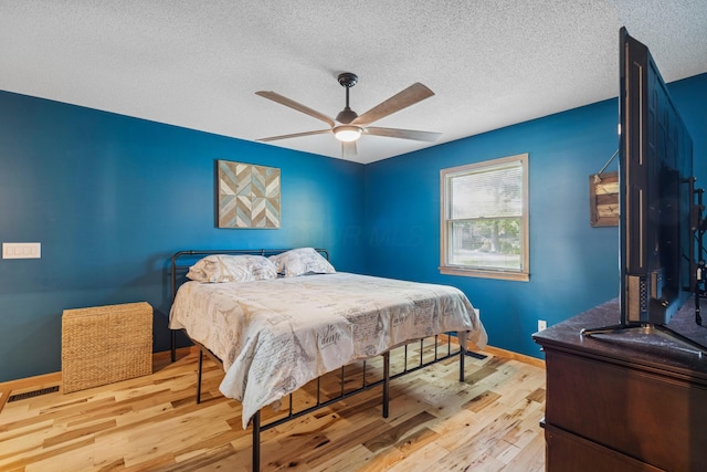 4490 N Bank Rd, Buckeye Lake, OH 43008 - bedroom with wood finished floors, a textured ceiling, and ceiling fan