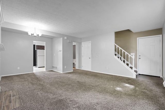 7607-7609 Penwood Pl, Columbus, OH 43235 - unfurnished living room featuring stairs, carpet, a chandelier, and a textured ceiling