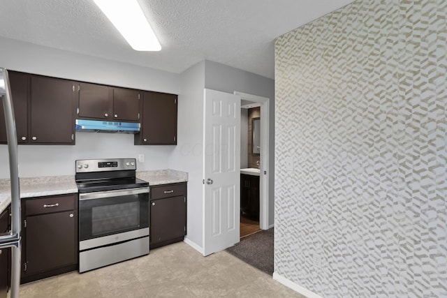 7607-7609 Penwood Pl, Columbus, OH 43235 - kitchen featuring electric stove, under cabinet range hood, light countertops, dark brown cabinetry, and a textured ceiling