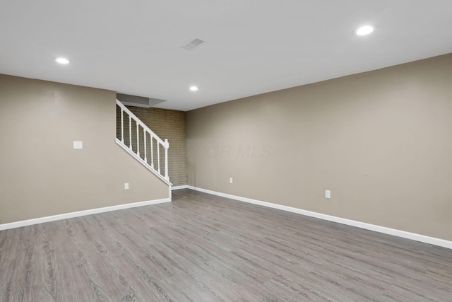 7607-7609 Penwood Pl, Columbus, OH 43235 - unfurnished living room featuring recessed lighting, wood finished floors, and stairway
