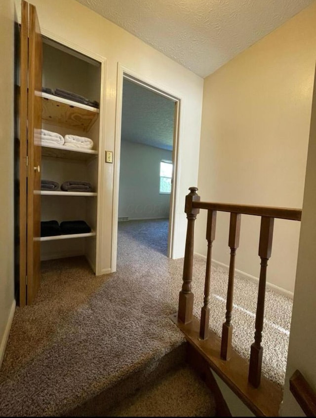 7607-7609 Penwood Pl, Columbus, OH 43235 - hallway featuring carpet flooring, a textured ceiling, and an upstairs landing