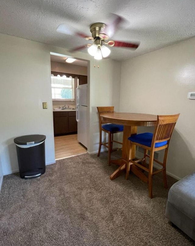 7607-7609 Penwood Pl, Columbus, OH 43235 - dining area with a ceiling fan, a textured ceiling, and light colored carpet