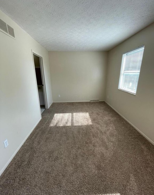 7607-7609 Penwood Pl, Columbus, OH 43235 - empty room featuring carpet flooring and a textured ceiling