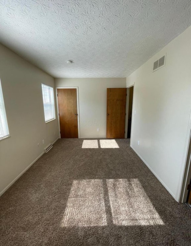 7607-7609 Penwood Pl, Columbus, OH 43235 - unfurnished room featuring carpet floors and a textured ceiling