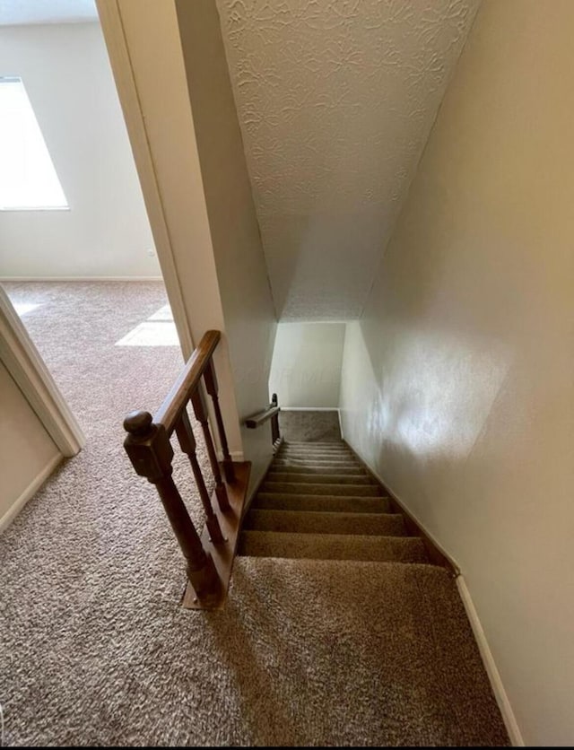 7607-7609 Penwood Pl, Columbus, OH 43235 - stairs with carpet floors, a textured ceiling, and vaulted ceiling