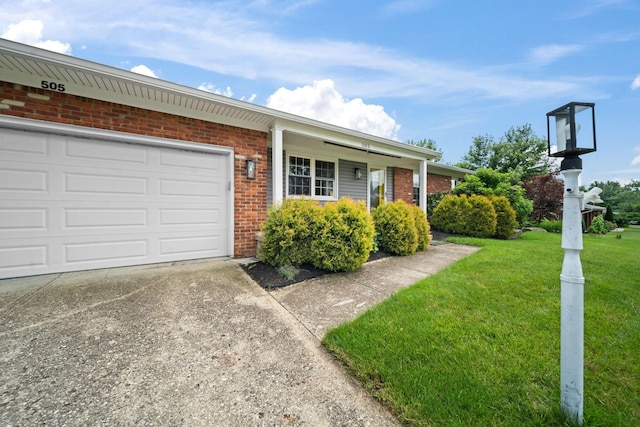 505 Tresham Rd, Columbus, OH 43230 - view of front of property with brick siding, driveway, a front lawn, and an attached garage
