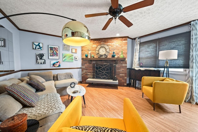 505 Tresham Rd, Columbus, OH 43230 - living room with a textured ceiling, wood finished floors, ceiling fan, ornamental molding, and a brick fireplace