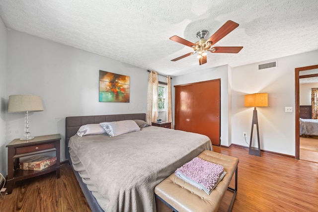 505 Tresham Rd, Columbus, OH 43230 - bedroom featuring wood finished floors, a closet, a textured ceiling, and ceiling fan