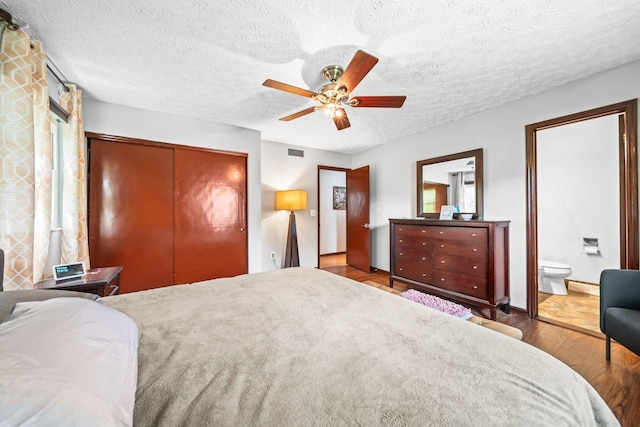 505 Tresham Rd, Columbus, OH 43230 - bedroom featuring a closet, wood finished floors, ceiling fan, ensuite bath, and a textured ceiling