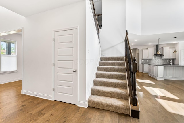 3622 Switchgrass Ct, Hilliard, OH 43026 - staircase with wood finished floors and arched walkways