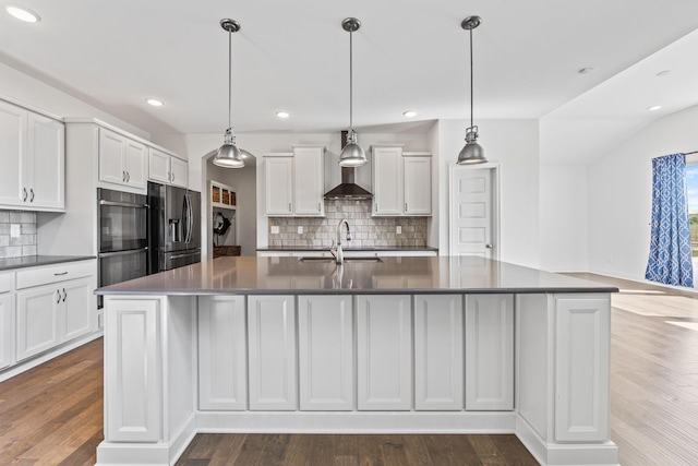 3622 Switchgrass Ct, Hilliard, OH 43026 - kitchen with refrigerator with ice dispenser, dark countertops, wall chimney range hood, decorative backsplash, and white cabinets