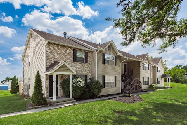 7831 Meadowhaven Blvd Unit 73, Columbus, OH 43235 - view of front facade with a front lawn and a shingled roof