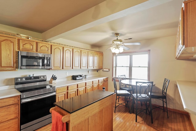 5255 State Route 138, Circleville, OH 43113 - kitchen featuring appliances with stainless steel finishes, ceiling fan, light wood-type flooring, and a kitchen island