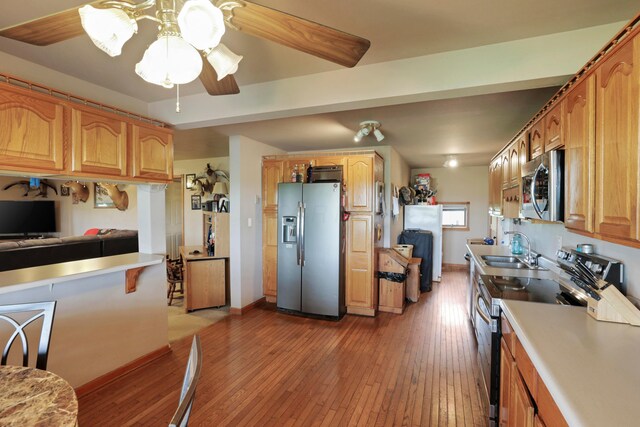 5255 State Route 138, Circleville, OH 43113 - kitchen featuring stainless steel appliances, light wood finished floors, light countertops, and a ceiling fan