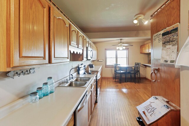 5255 State Route 138, Circleville, OH 43113 - kitchen with stainless steel appliances, light wood-type flooring, a ceiling fan, light countertops, and brown cabinetry