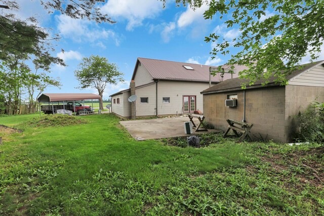 5255 State Route 138, Circleville, OH 43113 - back of house featuring a detached carport, a lawn, a metal roof, and a patio area