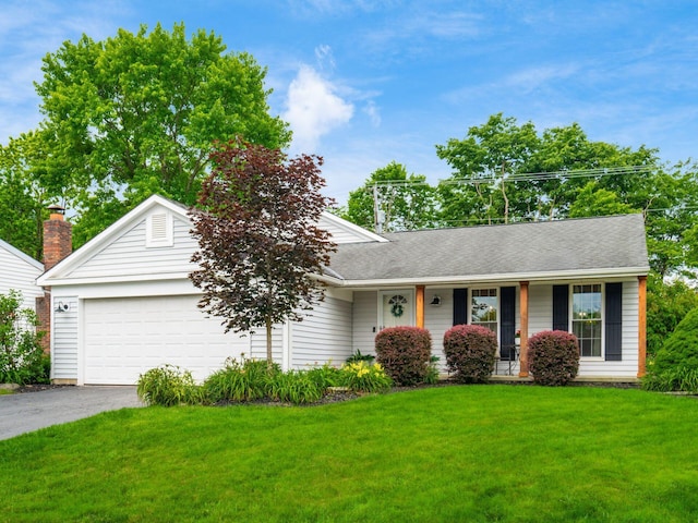 5611 Donnally Ct, Dublin, OH 43016 - ranch-style house featuring an attached garage, asphalt driveway, a front lawn, and covered porch