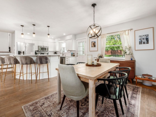 5611 Donnally Ct, Dublin, OH 43016 - dining area with light wood finished floors, a chandelier, and recessed lighting