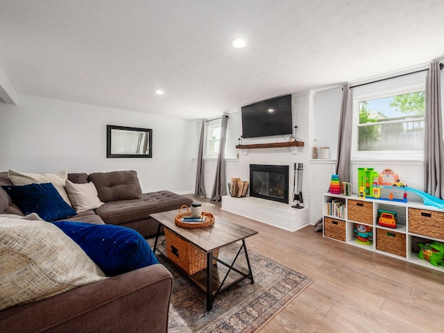 5611 Donnally Ct, Dublin, OH 43016 - living area with a brick fireplace, wood finished floors, and recessed lighting