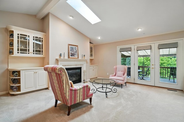 3175 Dartford Trce, Dublin, OH 43017 - living area featuring light colored carpet, a glass covered fireplace, a skylight, recessed lighting, and french doors