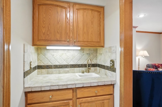 3175 Dartford Trce, Dublin, OH 43017 - kitchen with backsplash, light countertops, and ornamental molding
