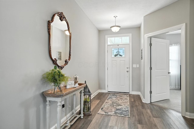 618 Ludham Trl, Pickerington, OH 43147 - foyer entrance featuring dark wood-style flooring and baseboards
