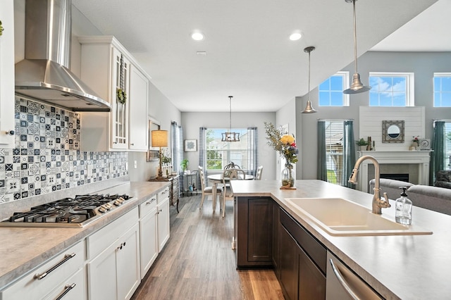 618 Ludham Trl, Pickerington, OH 43147 - kitchen with wall chimney range hood, stainless steel appliances, light wood-type flooring, glass insert cabinets, and light countertops
