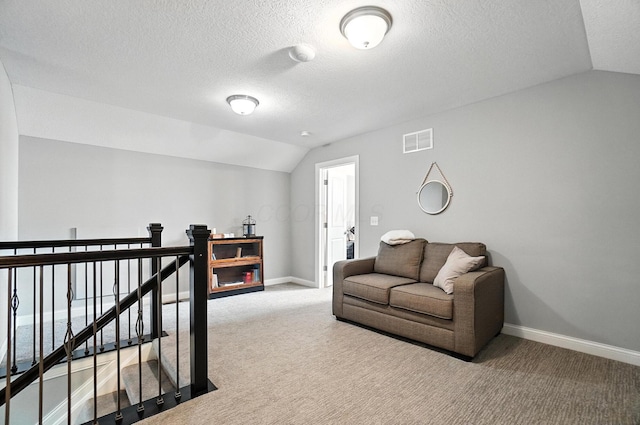 618 Ludham Trl, Pickerington, OH 43147 - living room featuring lofted ceiling, carpet floors, and a textured ceiling