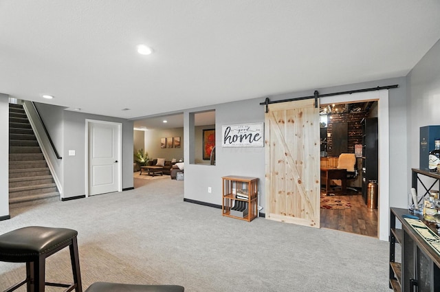 618 Ludham Trl, Pickerington, OH 43147 - carpeted living area featuring a barn door, stairs, and recessed lighting