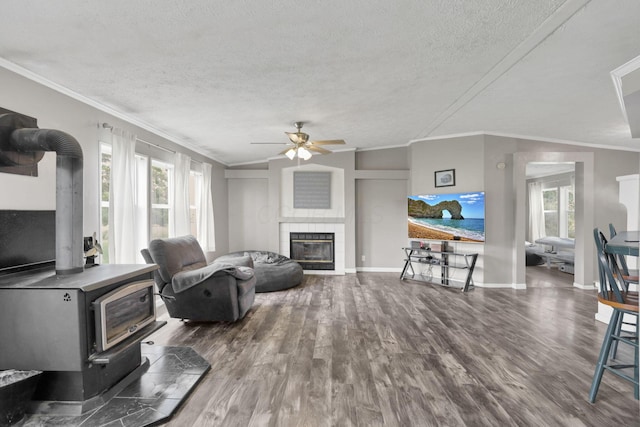 6471 Graham Rd, Mount Vernon, OH 43050 - living room with a tile fireplace, wood finished floors, ceiling fan, plenty of natural light, and a textured ceiling