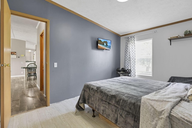 6471 Graham Rd, Mount Vernon, OH 43050 - bedroom with ornamental molding, a textured ceiling, wood finished floors, and lofted ceiling