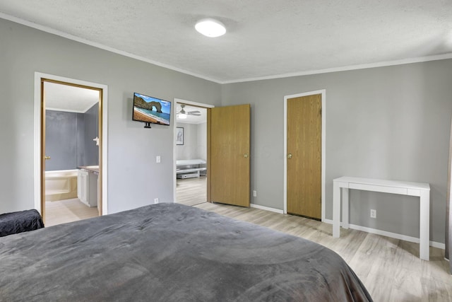 6471 Graham Rd, Mount Vernon, OH 43050 - bedroom with ornamental molding, light wood-style flooring, ensuite bathroom, and a textured ceiling