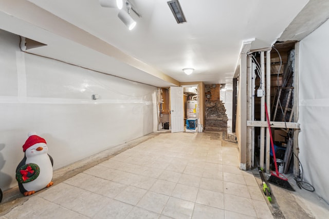 117 E Frankfort St, Columbus, OH 43206 - unfinished below grade area featuring light tile patterned floors and water heater