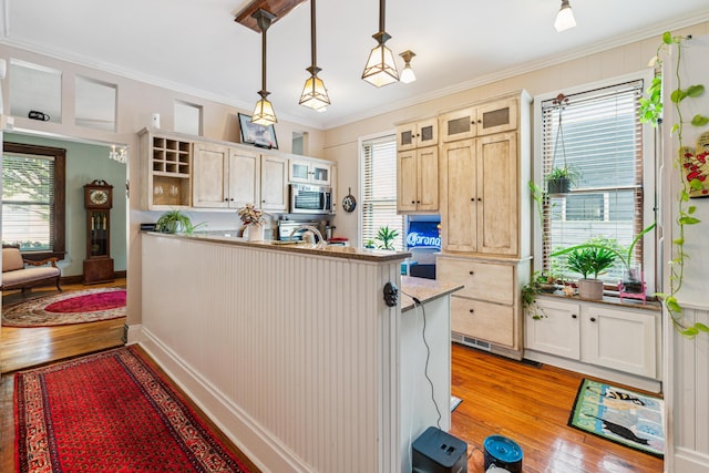 117 E Frankfort St, Columbus, OH 43206 - kitchen featuring stainless steel microwave, open shelves, light wood finished floors, a peninsula, and plenty of natural light