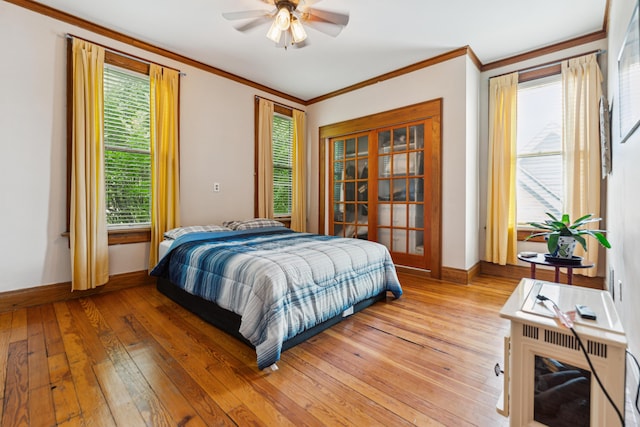 117 E Frankfort St, Columbus, OH 43206 - bedroom with light wood-style floors, crown molding, multiple windows, and a ceiling fan