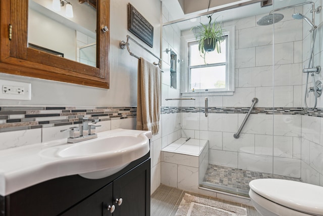 117 E Frankfort St, Columbus, OH 43206 - bathroom featuring tile walls, a stall shower, and vanity