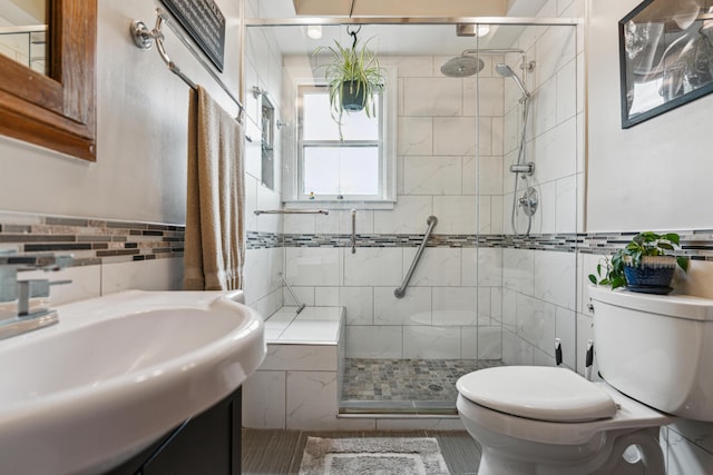 117 E Frankfort St, Columbus, OH 43206 - bathroom with tile walls, a shower stall, and vanity