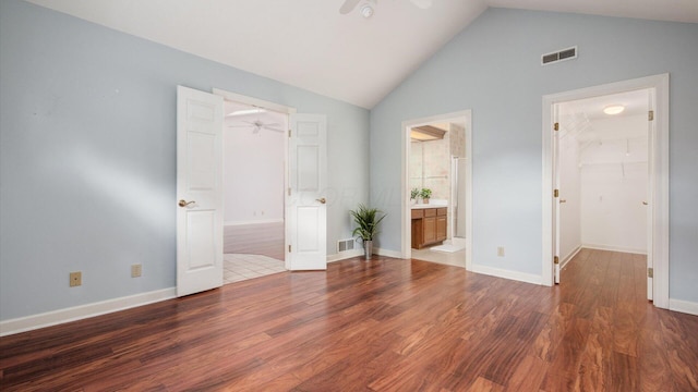 74 Stonington Cir, Newark, OH 43055 - unfurnished bedroom featuring a walk in closet, wood finished floors, ensuite bath, a closet, and high vaulted ceiling