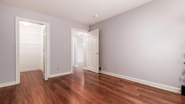 74 Stonington Cir, Newark, OH 43055 - unfurnished bedroom with dark wood-style flooring, a walk in closet, and a closet