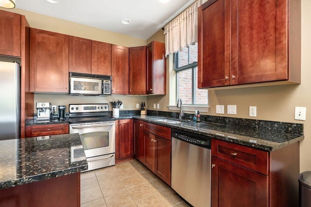250 Daniel Burnham Sq Unit 402, Columbus, OH 43215 - kitchen with appliances with stainless steel finishes, dark stone counters, and light tile patterned floors