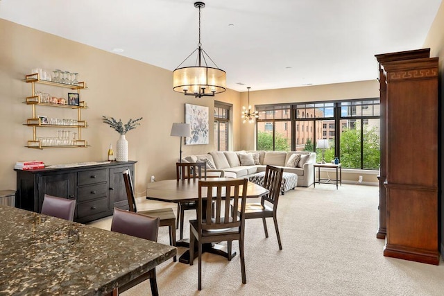 250 Daniel Burnham Sq Unit 402, Columbus, OH 43215 - dining area featuring a chandelier and light colored carpet