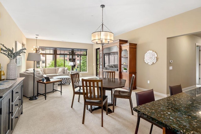 250 Daniel Burnham Sq Unit 402, Columbus, OH 43215 - dining space featuring a chandelier and light carpet