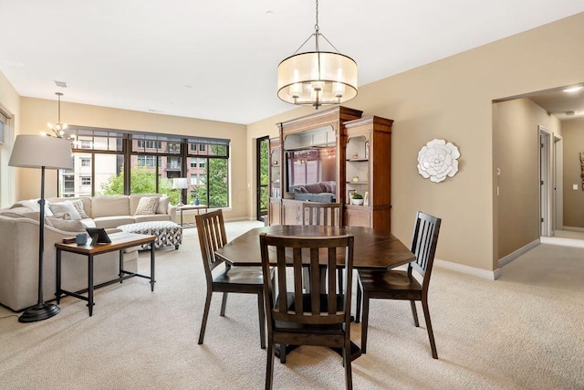 250 Daniel Burnham Sq Unit 402, Columbus, OH 43215 - dining space featuring a chandelier and light carpet