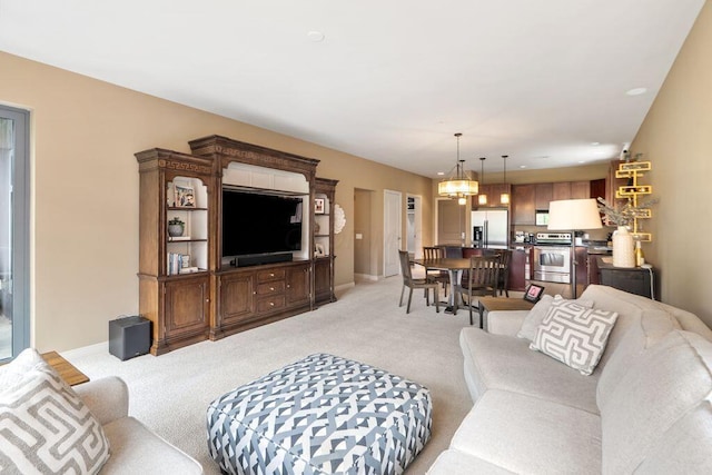 250 Daniel Burnham Sq Unit 402, Columbus, OH 43215 - living room with light carpet and a chandelier