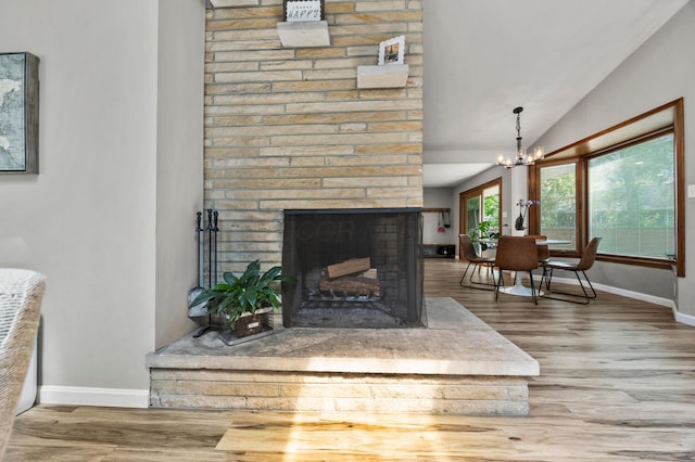 298 Flint Ridge Dr, Columbus, OH 43230 - detailed view of wood finished floors, a brick fireplace, and a chandelier