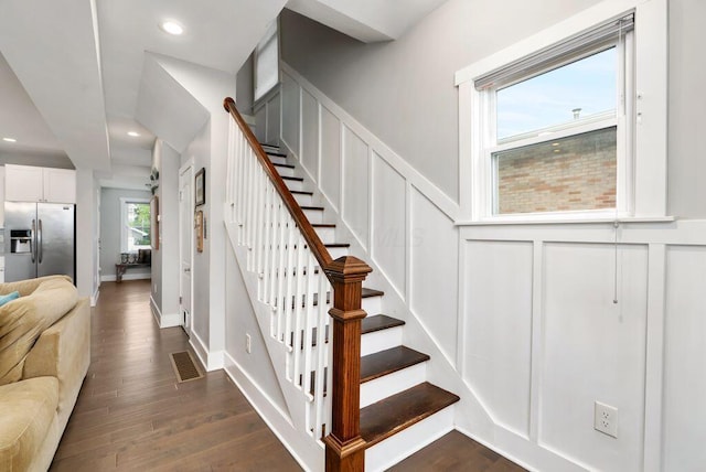 497 E Kossuth St, Columbus, OH 43206 - staircase featuring a decorative wall, wood finished floors, wainscoting, and recessed lighting