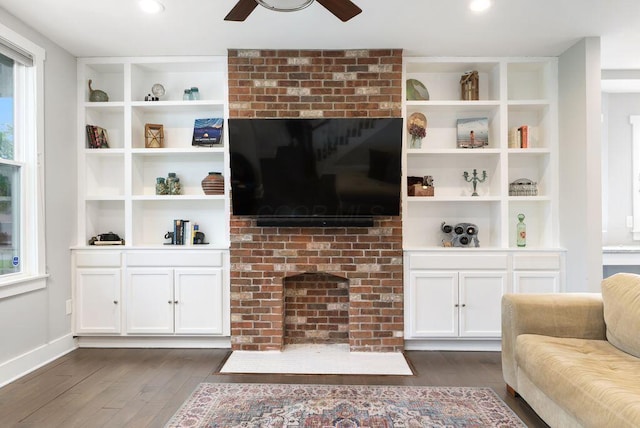 497 E Kossuth St, Columbus, OH 43206 - living room with a fireplace, dark wood-type flooring, ceiling fan, and built in shelves