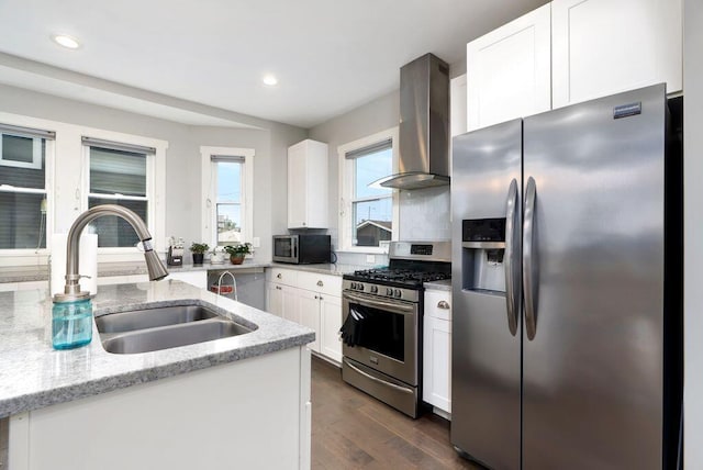 497 E Kossuth St, Columbus, OH 43206 - kitchen featuring stainless steel appliances, wall chimney exhaust hood, white cabinetry, dark wood finished floors, and recessed lighting