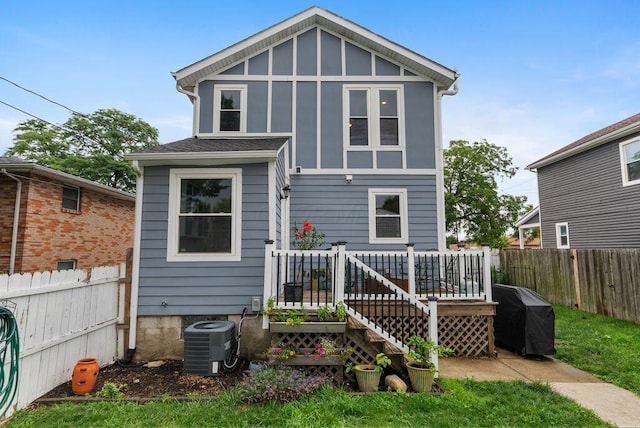 497 E Kossuth St, Columbus, OH 43206 - back of house with a fenced backyard, a deck, and board and batten siding
