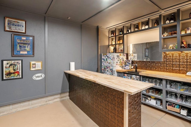 497 E Kossuth St, Columbus, OH 43206 - bar area featuring freestanding refrigerator and decorative backsplash